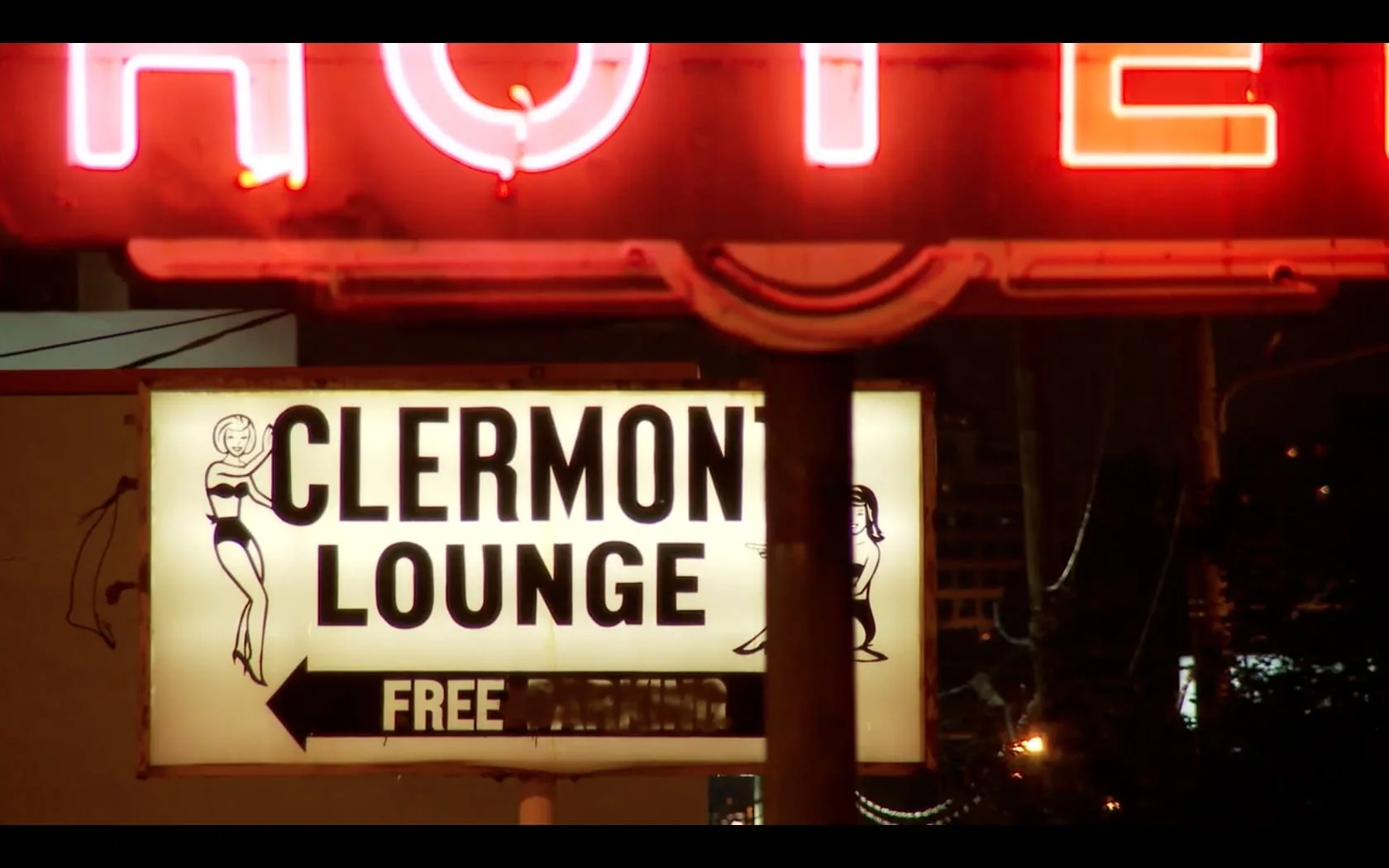 Clermont Lounge pin-up sign lit under the hotel neon at night