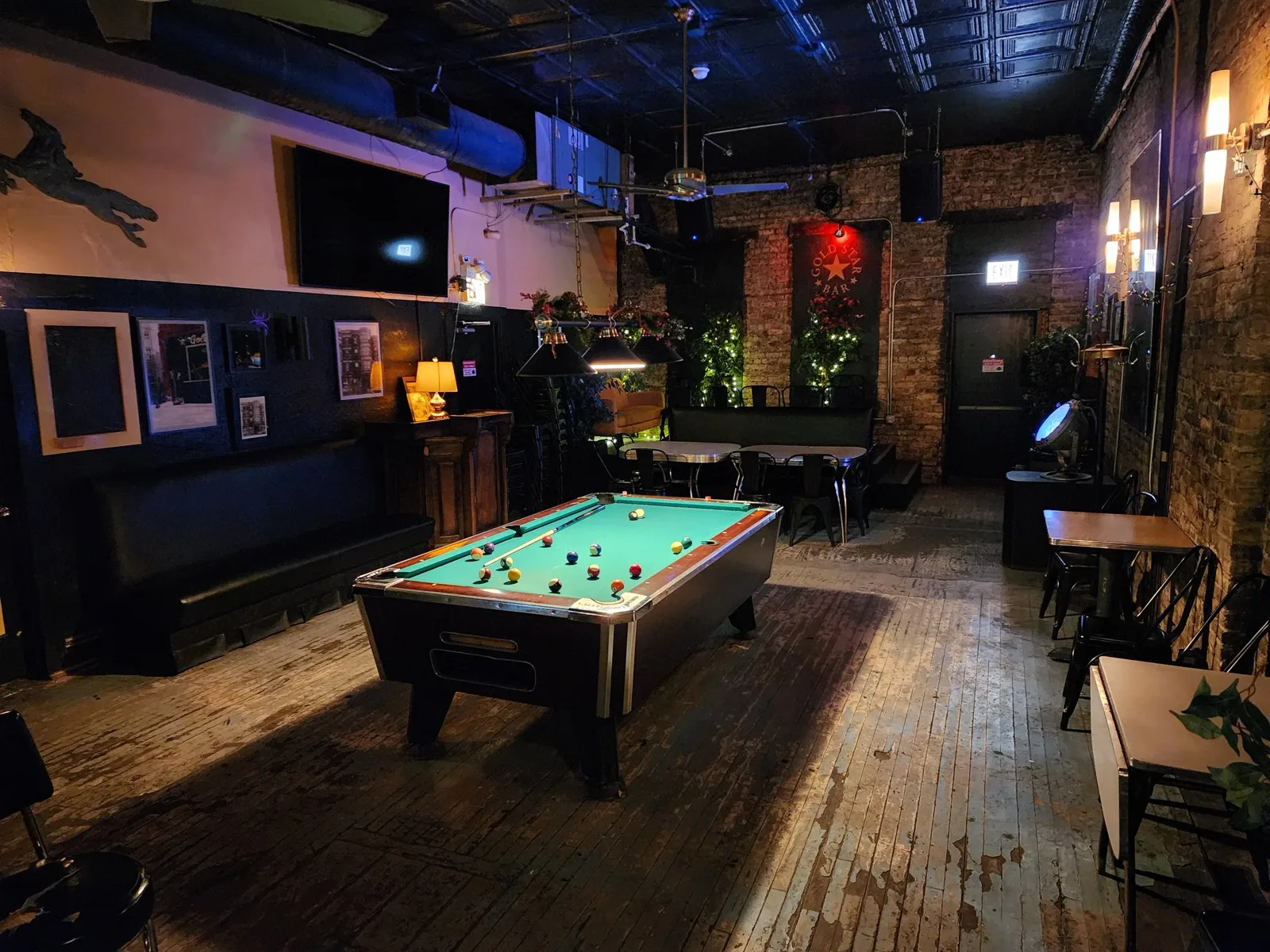 The pool table and Gold Star Bar banner in the back room