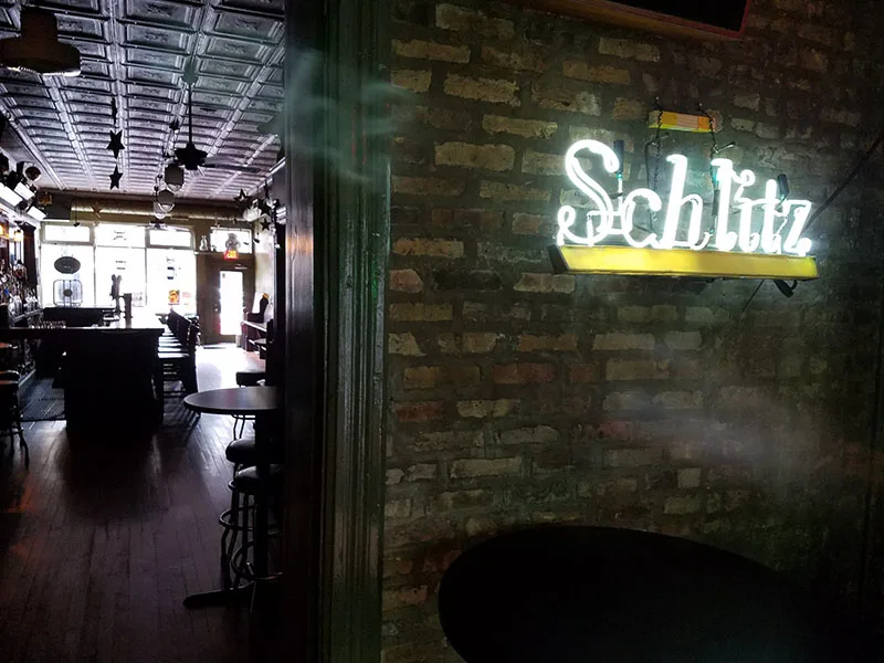 Schlitz neon, exposed brick, and a tin ceiling in the Lemming's Tavern room